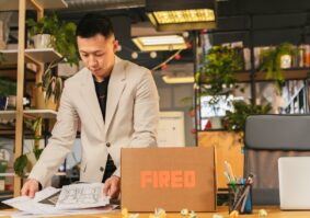 Asian man packing up his desk
