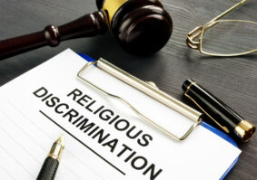 religious discrimination claim and a pen on a table