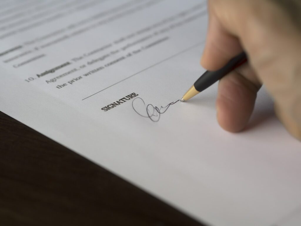 closeup of a person signing a contract