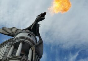 fire breathing dragon on top of a building